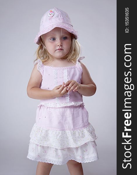 Innocent little girl dressed in pink looking sad. Innocent little girl dressed in pink looking sad