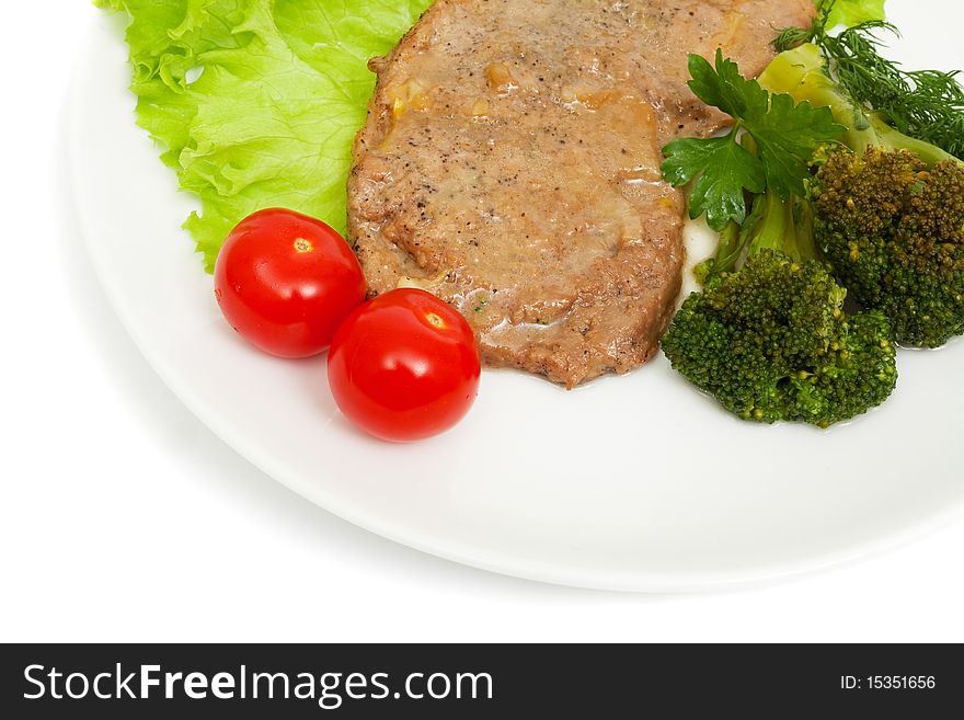 Escalope of veal with onion sauce and boiled broccoli isolated on white