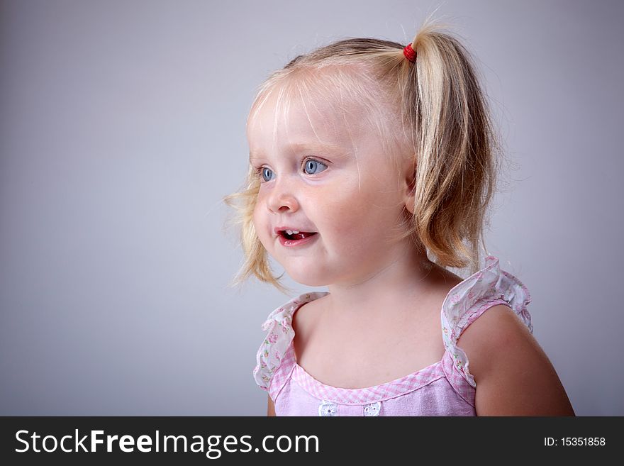 Little blonde girl with pigtails portrait