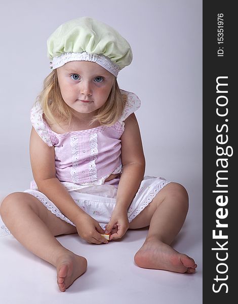 Small cute little girl sitting on the floor. Small cute little girl sitting on the floor