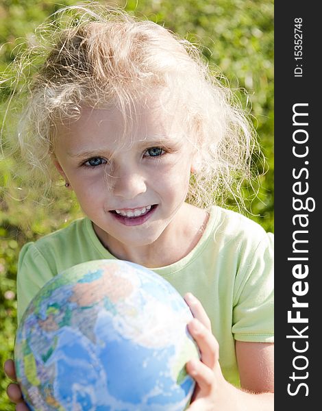 Little girl holding globe. Concept: Earth in future generations hands