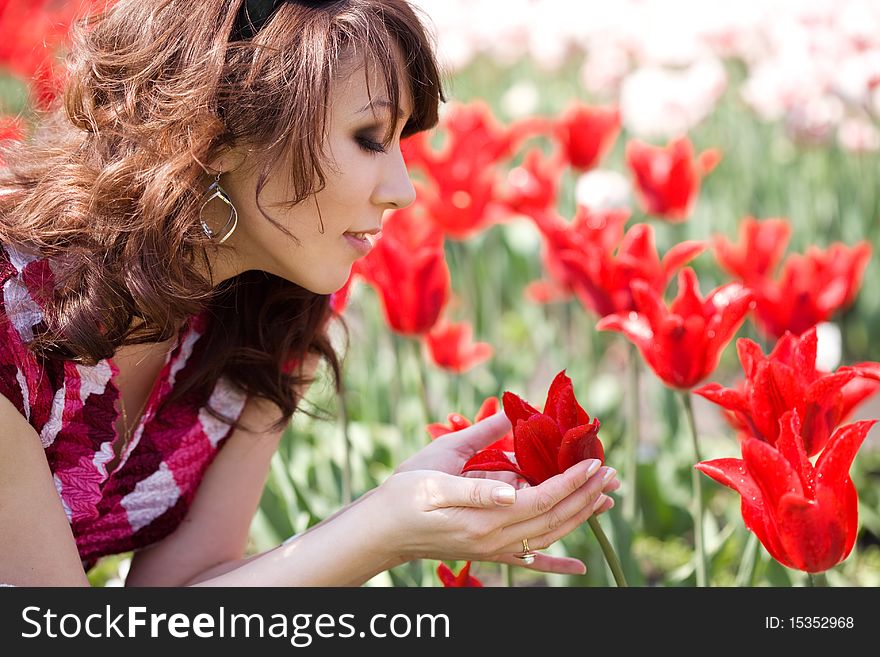 Tender girl in the garden with tulips
