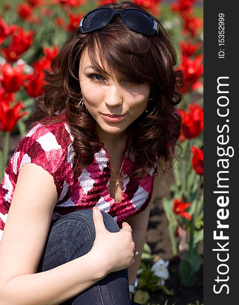 Tender girl in the garden with tulips