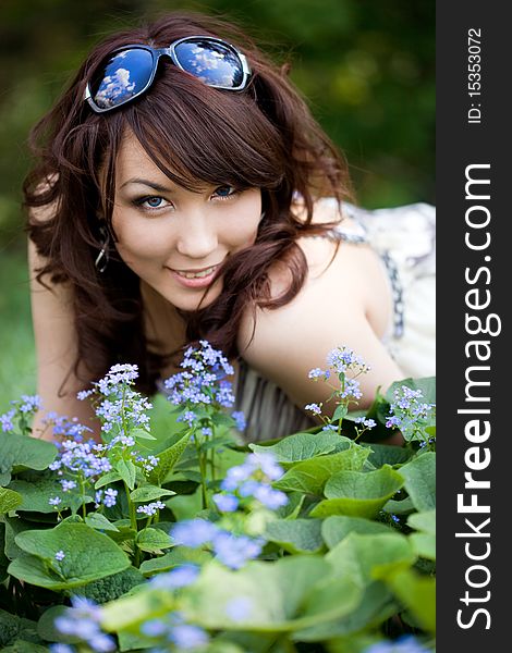 Tender girl in the garden with flowers