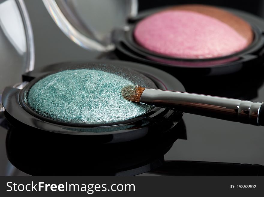 Make-up eyeshadows and cosmetic brush