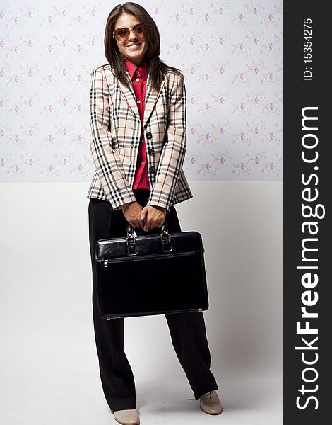 The happy young girl in a checkered jacket