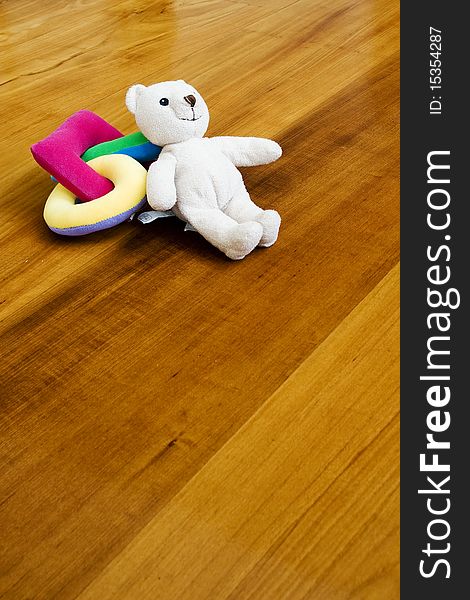 Bear and toy on wooden ground