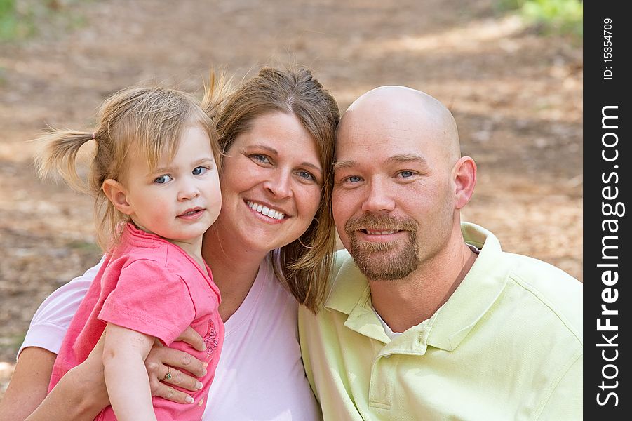 Couple With Their Daughter at the Park. Couple With Their Daughter at the Park