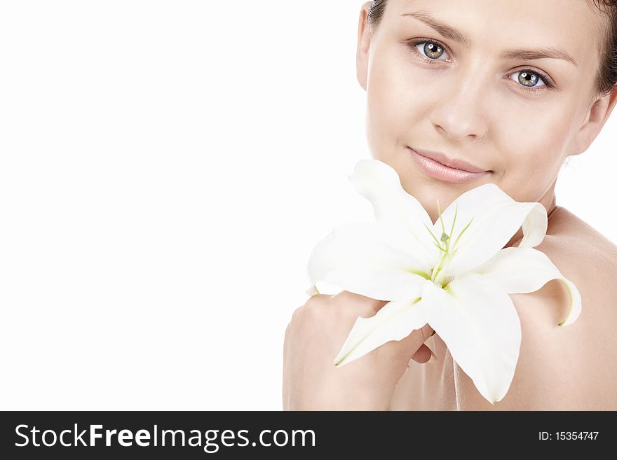 Young beautiful girl with a lily on a white background