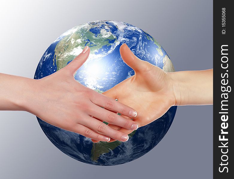 Business handshake on the background of the Earth. The symbol of a successful business.