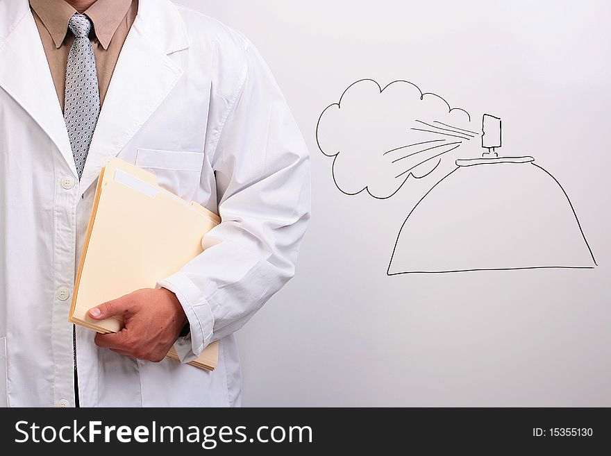 Man in a white lab coat holding manila folders while standing next to a drawing of spray. Man in a white lab coat holding manila folders while standing next to a drawing of spray.