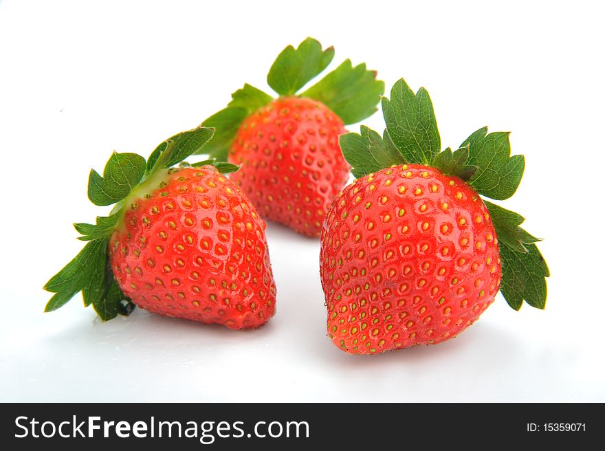 Three fresh strawberries isolated on white background. Three fresh strawberries isolated on white background.
