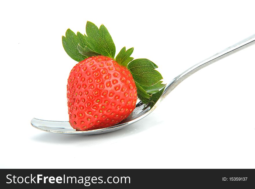 Single ripe fresh strawberry on spoon isolated on white