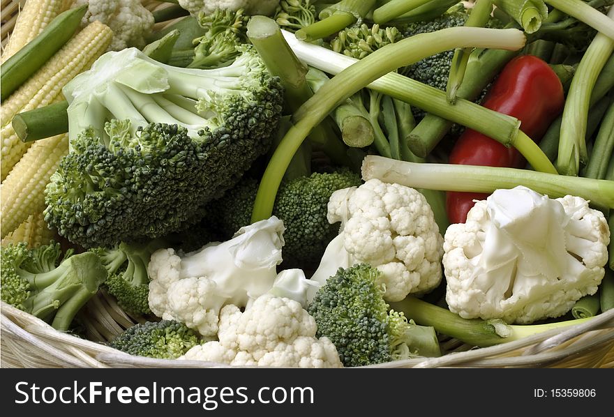 A close up of lots of varieties of summer vegetables in a basket. A close up of lots of varieties of summer vegetables in a basket