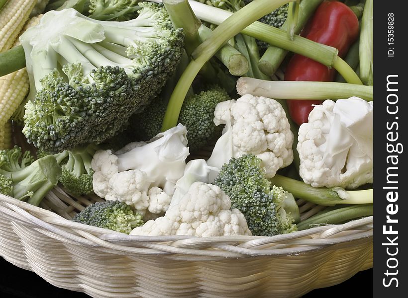 A close up of summer vegetables in a basket. A close up of summer vegetables in a basket