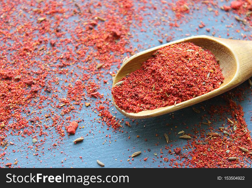 Spices In A Wooden Spoon. Various Indian Spices On Black Stone Table