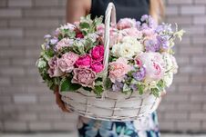 Flower Arrangement In Wicker Basket. Beautiful Bouquet Of Mixed Flowers In Woman Hand. Floral Shop Concept . Handsome Stock Photos