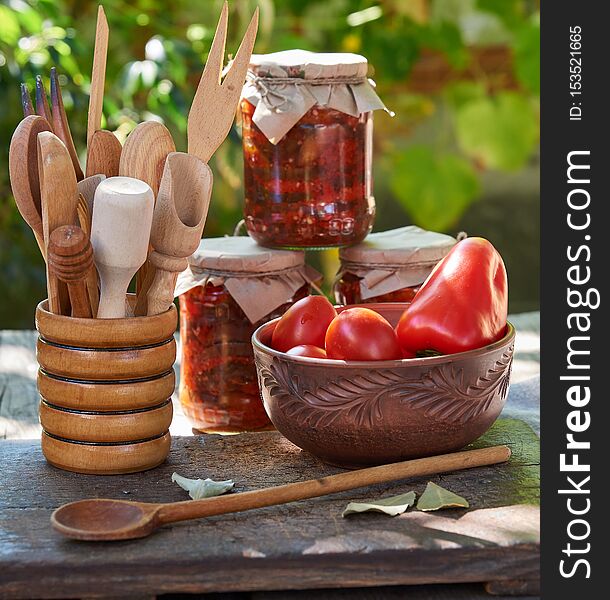 canned eggplant with vegetables on a brown wooden board, close up