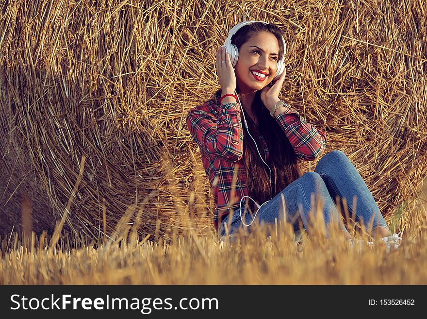 Girl with a beautiful smile enjoying music.