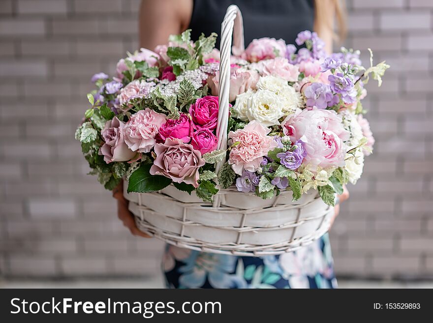 Flower Arrangement In Wicker Basket. Beautiful Bouquet Of Mixed Flowers In Woman Hand. Floral Shop Concept . Handsome