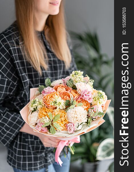Beautiful bouquet of mixed flowers in woman hand. Floral shop concept . Handsome fresh bouquet. Flowers delivery.