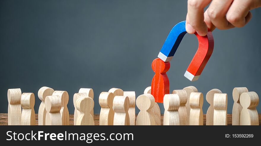 Businessman pulls out a red figure of a man from the crowd with the help of a magnet. leader manages the business and forms a team. toxic, incompetent worker. Increase team efficiency, productivity