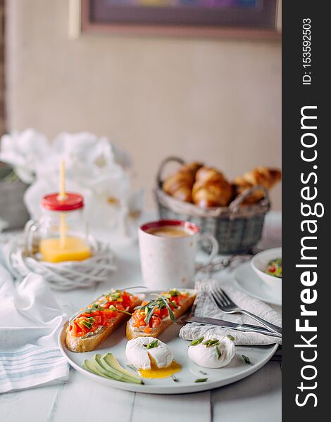 Norway Breakfast. Toasts With Salmon, Boiled Eggs On White Wooden Table With Salad, Coffee, Orange Juice And Croissants