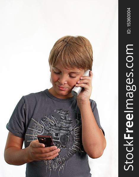 Boy talking on a cell phone, isolated . Boy talking on a cell phone, isolated .