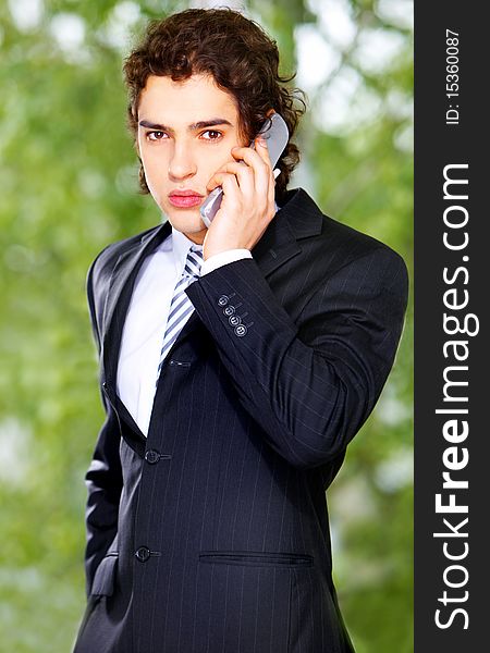 Portrait of a young businessman with telephone