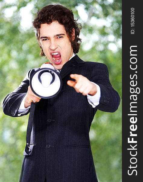 Portrait of a young businessman with megaphone