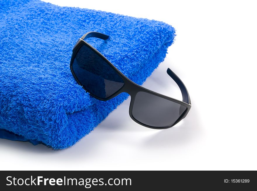 Towel and sunglasses on a white background