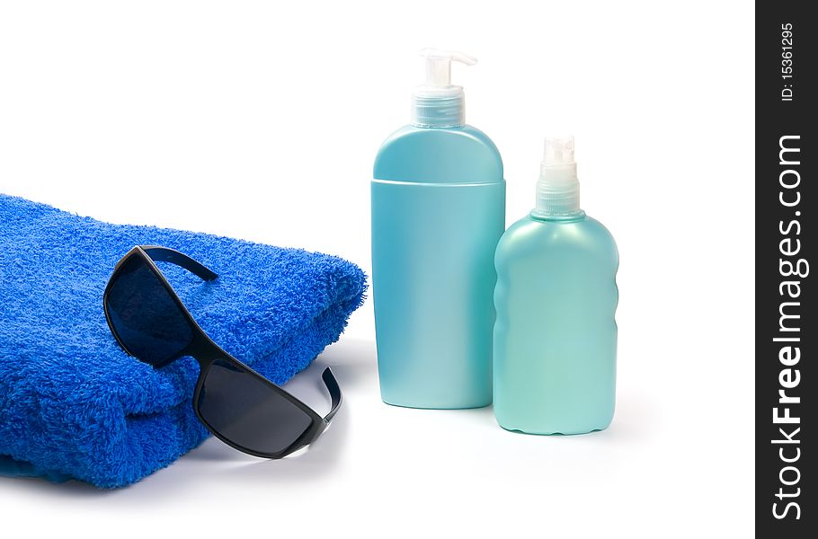 Sunglasses, sun lotion and towel on white background. Sunglasses, sun lotion and towel on white background