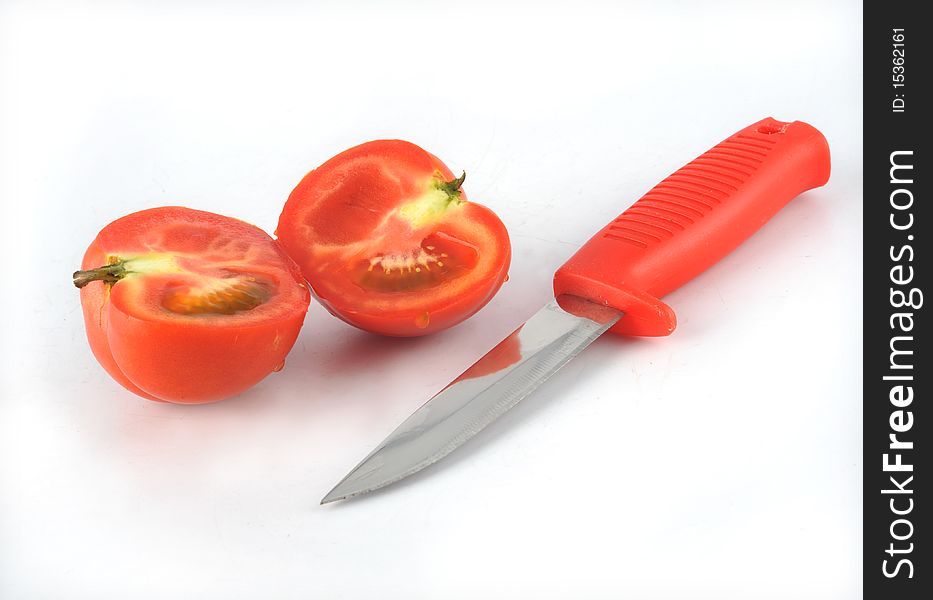Tomato and knife in white background