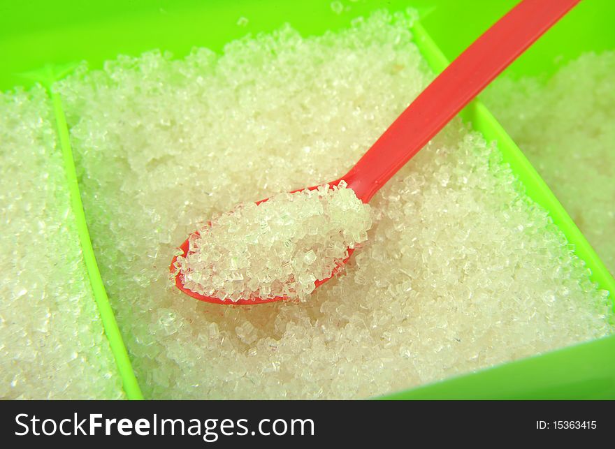 Close-up white sugar and spoon