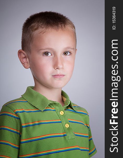 Young boy in green blouse with colorful stripes portrait. Young boy in green blouse with colorful stripes portrait