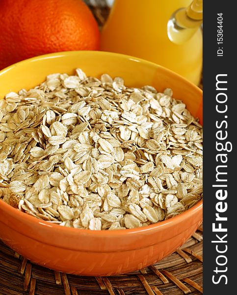 Oats in bowl on wooden, food ingredient