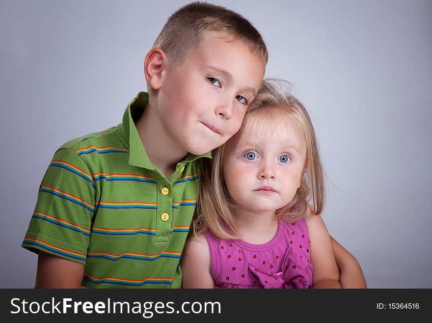 Two beautiful kids, brother and sister, in photo studio. Two beautiful kids, brother and sister, in photo studio