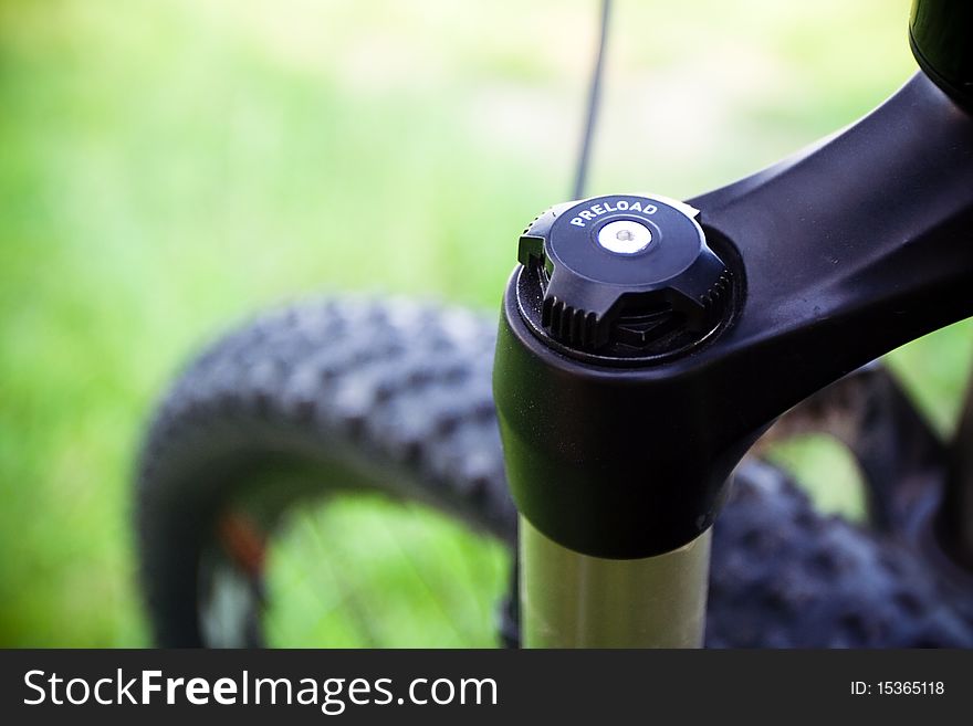 Mountain bike ready for ride outdoors, suspension fork detail. Mountain bike ready for ride outdoors, suspension fork detail