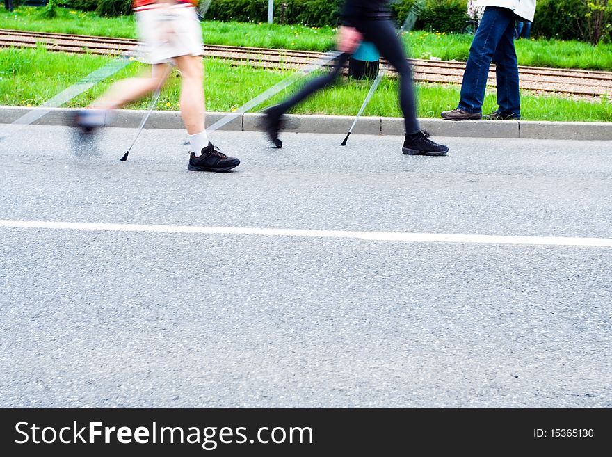 People on nordic walking race on city streets. People on nordic walking race on city streets
