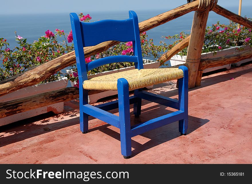 Teak patio chair on the beach