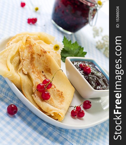 Pancakes with red currant jam for breakfast. Pancakes with red currant jam for breakfast