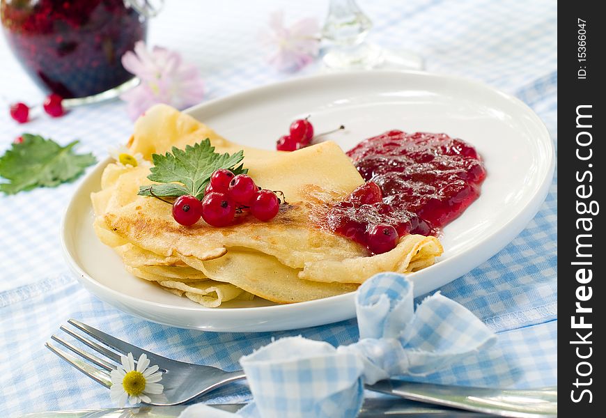 Pancakes with currant jam for breakfast. Pancakes with currant jam for breakfast