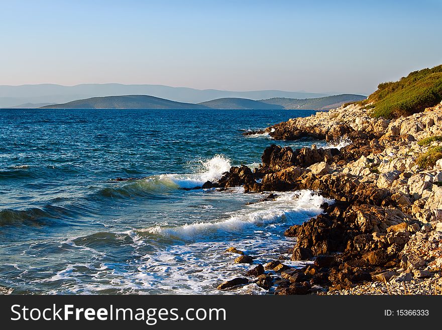Beautiful view of the mountains and coast with rocks at Aegean Sea. Beautiful view of the mountains and coast with rocks at Aegean Sea
