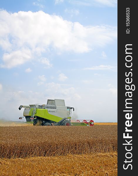 Modern combine harvester working on a wheat crop. Modern combine harvester working on a wheat crop