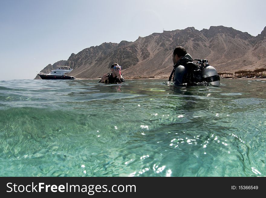 Scuba divers with dessert backdrop. Scuba divers with dessert backdrop