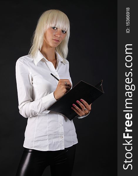 Beautiful business blonde lady looks at you with folder in hand