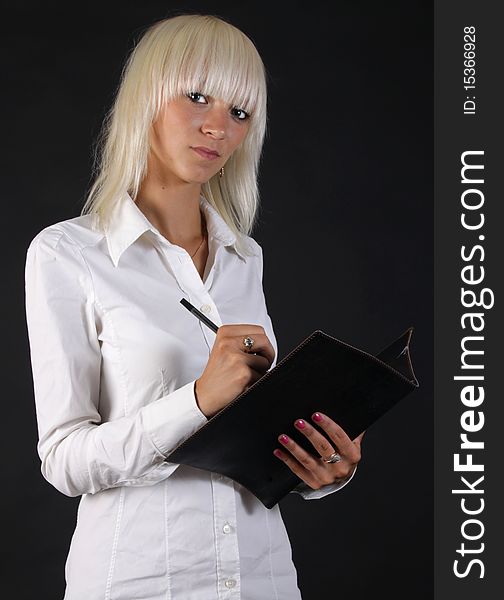 Beautiful business blonde lady looks at you with folder in hand