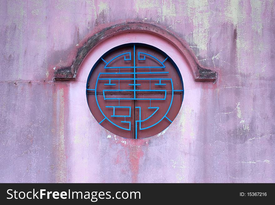 Circle chinese style window on the red wall ,vertical