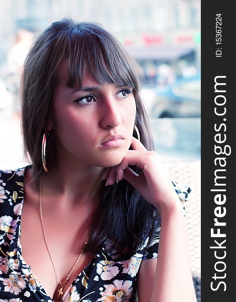 Beautiful young woman in a summer cafe