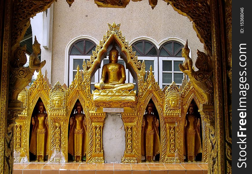 Beautiful golden buddha statue in a temple wall.The temple was located in central part of Thailand